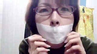 Asian girl self gag mouth tape